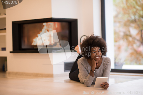 Image of black women using tablet computer on the floor