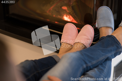 Image of Young couple  in front of fireplace