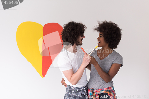 Image of couple with painted heart on wall