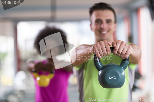 Image of couple  workout with weights at  crossfit gym