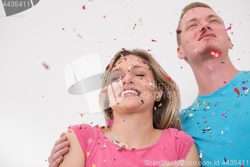 Image of romantic young  couple celebrating  party with confetti