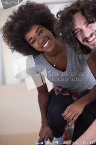 Image of multiethnic couple renovating their home