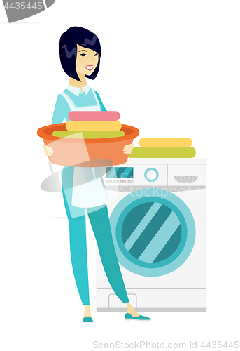 Image of Housewife using washing machine at laundry.