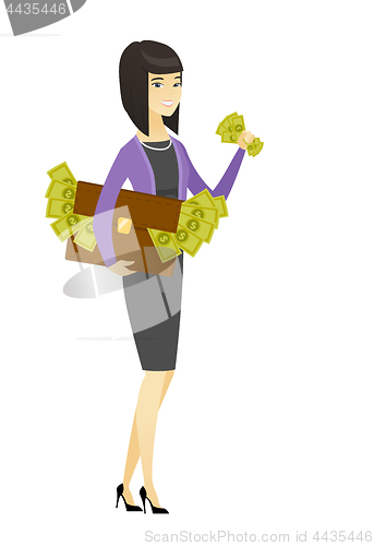 Image of Business woman with briefcase full of money.