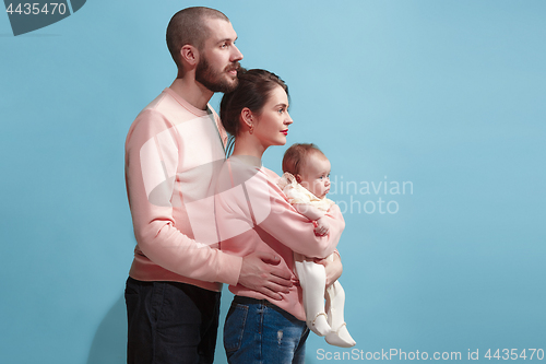 Image of Happy family on the blue studio background
