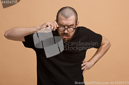 Image of The young emotional angry man on pastel studio background