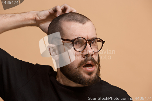 Image of Young serious thoughtful businessman. Doubt concept.