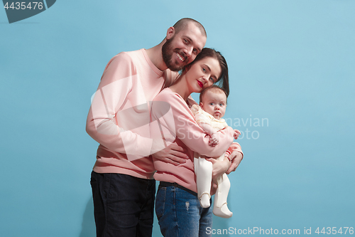 Image of Happy family on the blue studio background