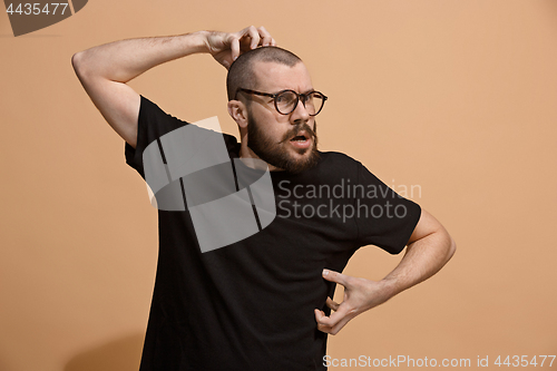 Image of Young serious thoughtful businessman. Doubt concept.