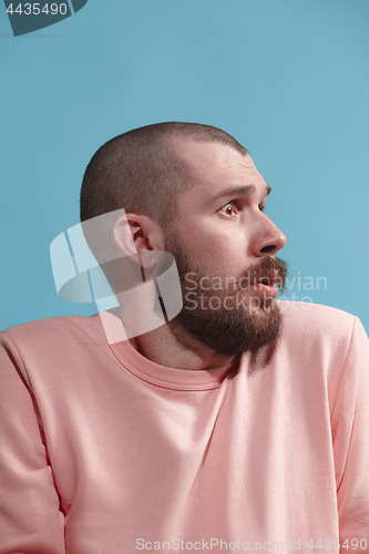 Image of Isolated on blue young casual man is afraid at studio