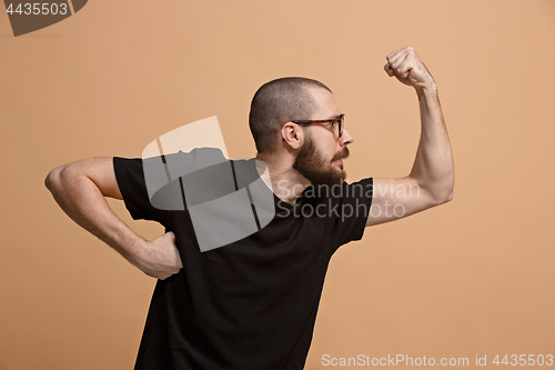 Image of The young emotional angry man on pastel studio background