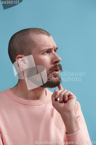 Image of Young serious thoughtful businessman. Doubt concept.