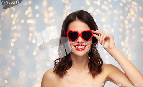 Image of woman with red lipstick and heart shaped shades