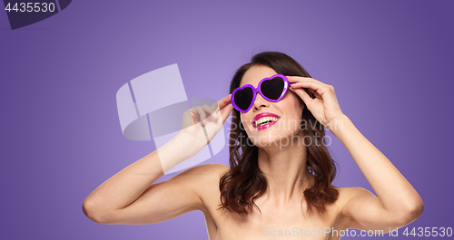 Image of woman with pink lipstick and heart shaped shades