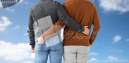 Image of close up of hugging male gay couple