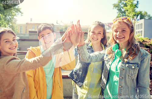 Image of happy students or friends making high five