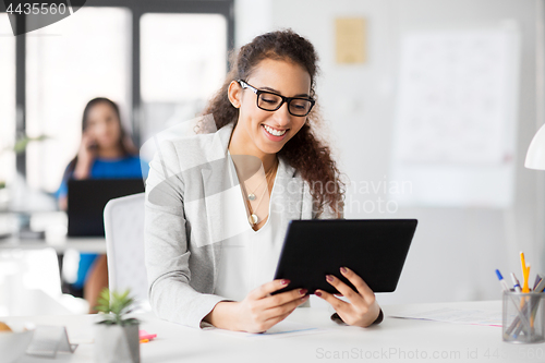 Image of businesswoman with tablet pc working at office