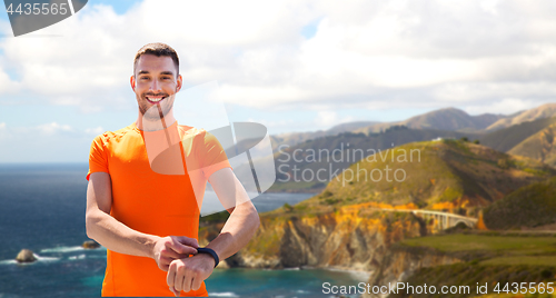 Image of man with fitness tracker training outdoors