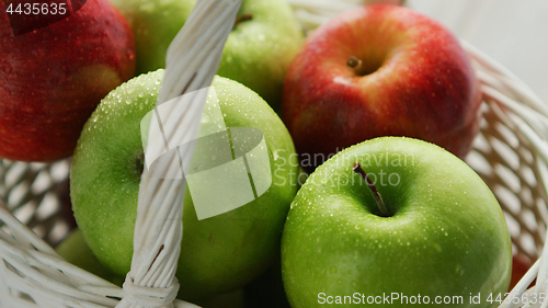 Image of Mixed green and red apples in basket