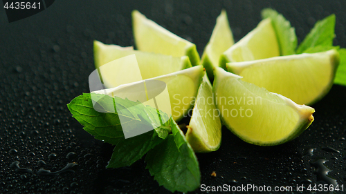 Image of Lime segments with mint leaves