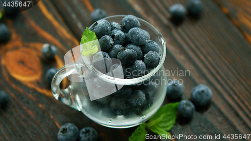 Image of Jug full of blueberry with green leaf 