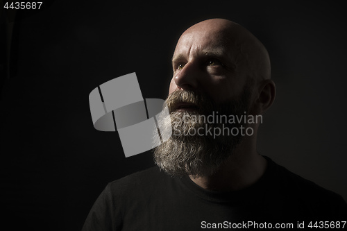 Image of a dark male portrait in classic rembrandt light