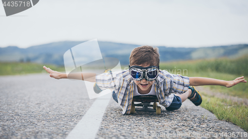 Image of Happy little boy playing on the road at the day time. 