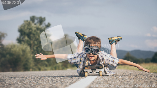 Image of Happy little boy playing on the road at the day time.