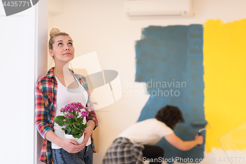 Image of happy young couple doing home renovations