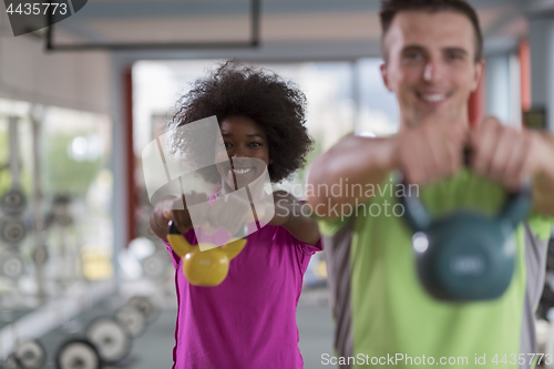 Image of couple  workout with weights at  crossfit gym