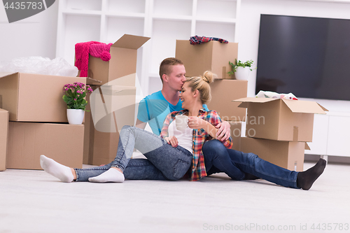 Image of young couple moving  in new house