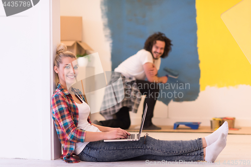 Image of Happy couple doing home renovations