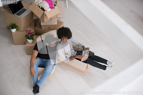 Image of African American couple  playing with packing material