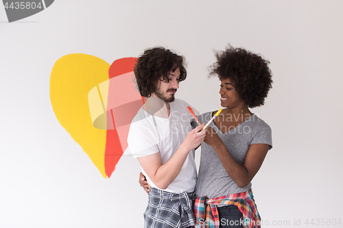 Image of couple with painted heart on wall