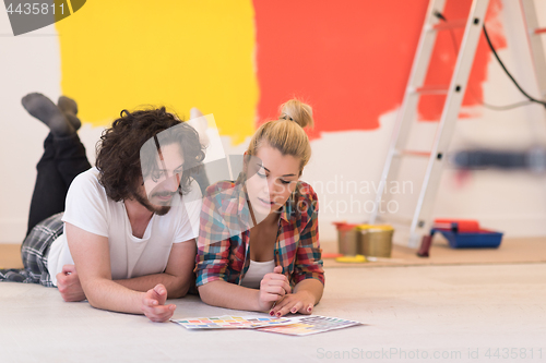Image of Happy young couple relaxing after painting