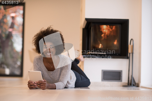 Image of black women using tablet computer on the floor