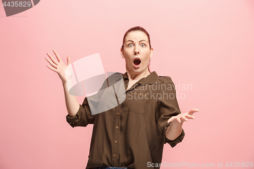 Image of Beautiful woman looking suprised isolated on pink