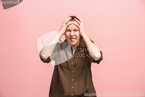 Image of Beautiful woman looking suprised and bewildered isolated on pink