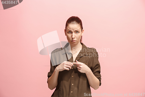 Image of Beautiful woman looking suprised and bewildered isolated on pink