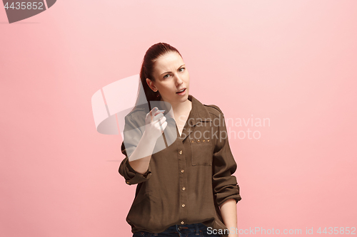 Image of The overbearing business woman point you and want you, half length closeup portrait on pink background.