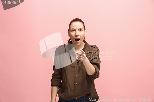 Image of The happy business woman point you and want you, half length closeup portrait on pink background.