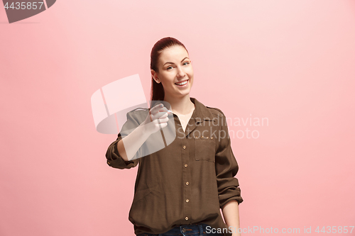 Image of The happy business woman point you and want you, half length closeup portrait on pink background.