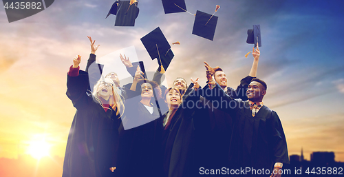 Image of happy graduates or students throwing mortar boards