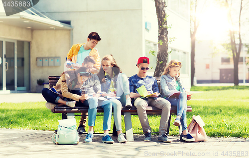 Image of group of students with notebooks at school yard