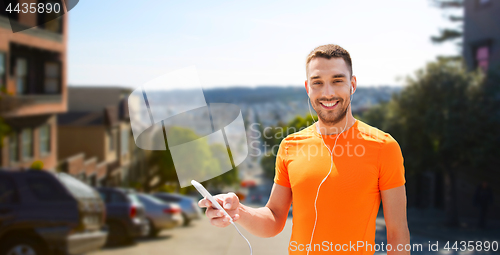 Image of man with smartphone and earphones in san francisco