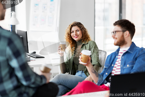 Image of creative team drinking coffee at office