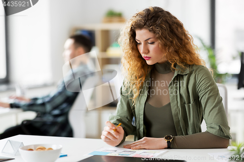 Image of creative woman working on user interface at office