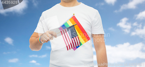 Image of man with gay pride rainbow flag and wristband