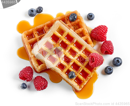 Image of waffles decorated with honey and berries