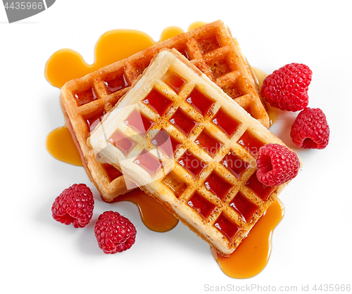 Image of waffles with syrup and raspberries